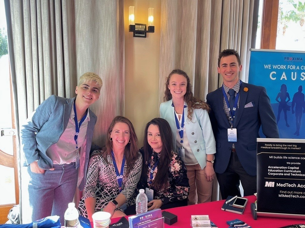 The Proxima CRO team and sponsorship table at LSI USA ‘22 Conference