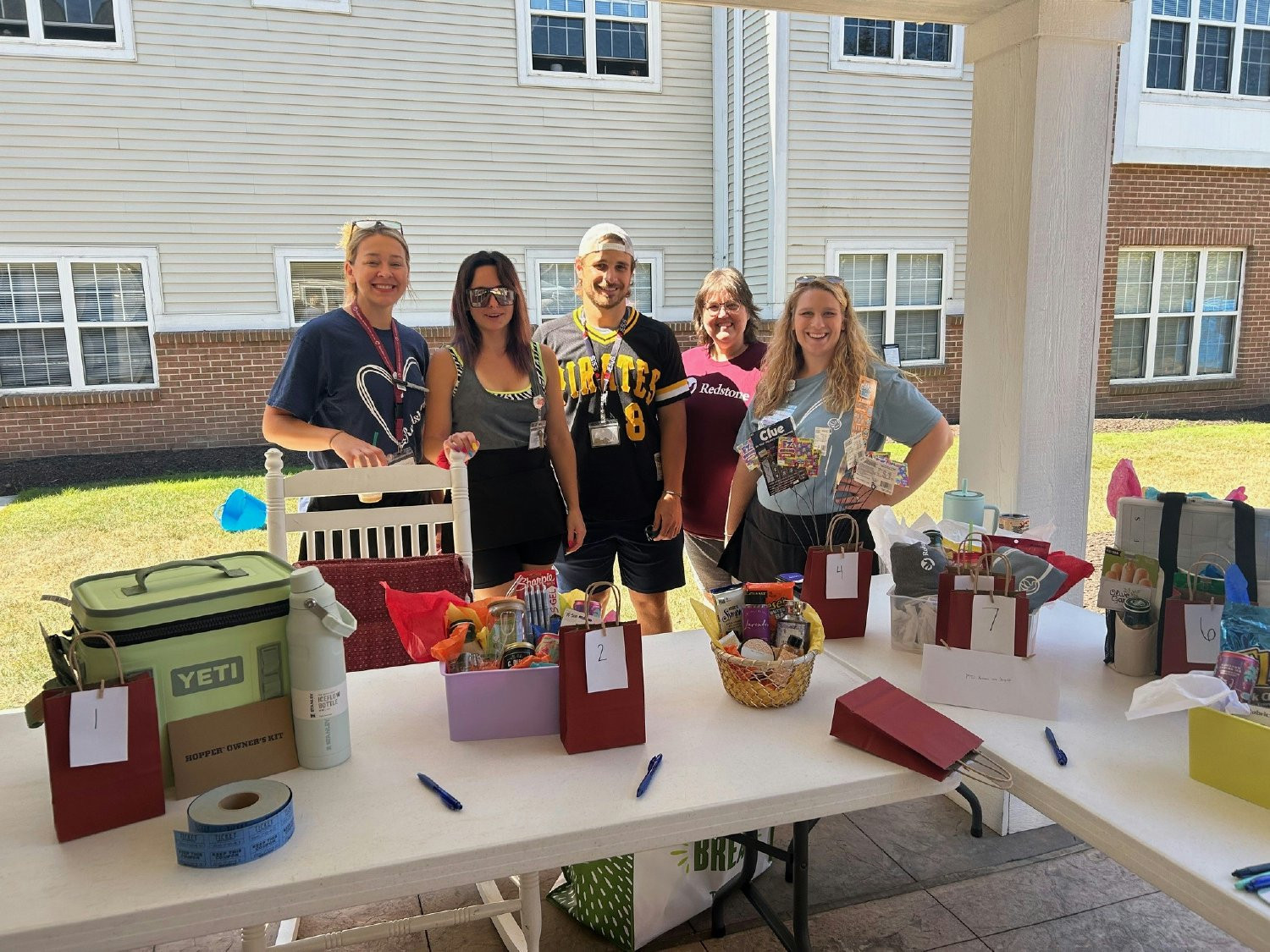 Celebrating at a congratulatory outdoor picnic featuring a grilled lunch, dunk tank, raffles and fun