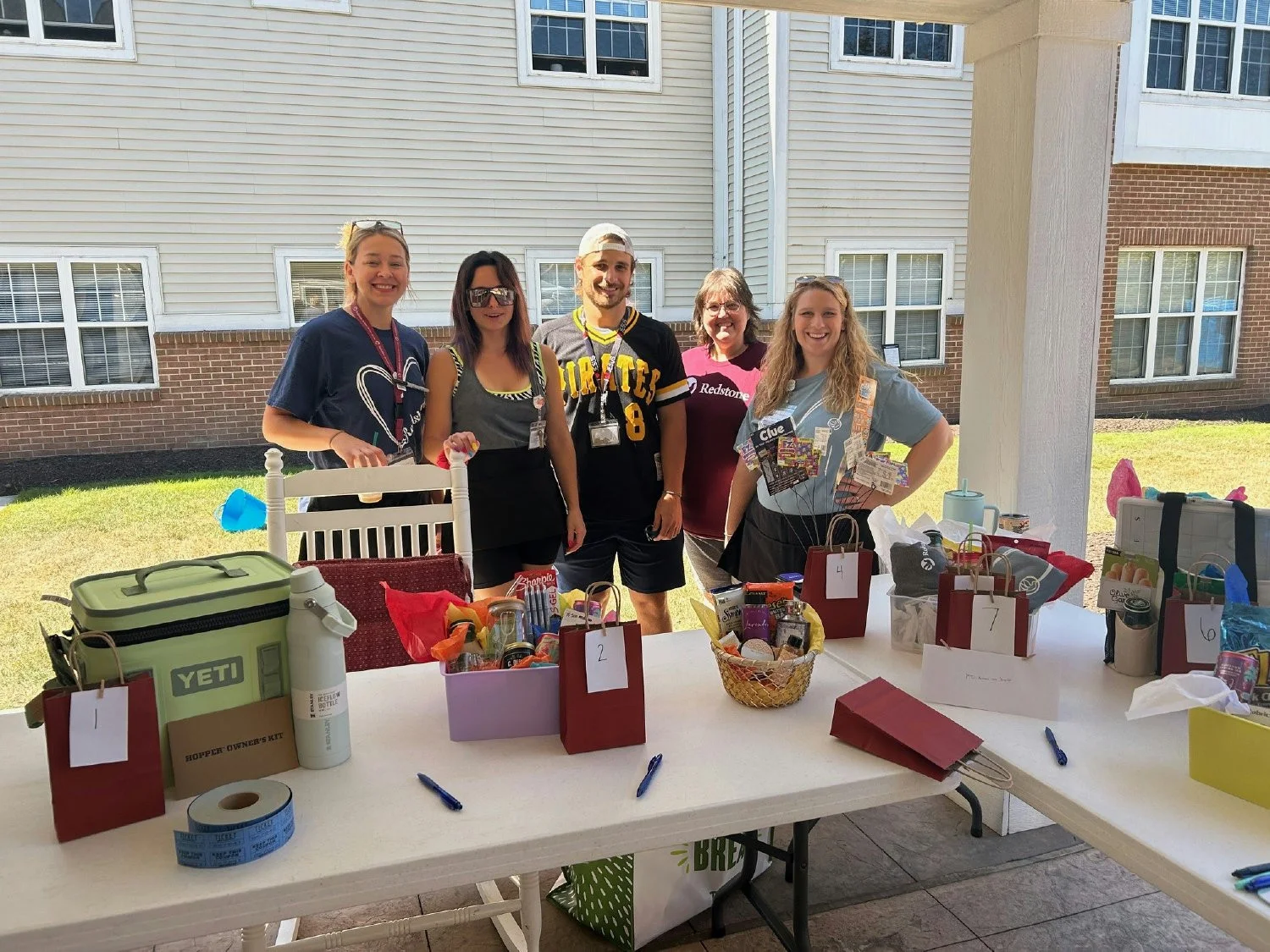 Celebrating at a congratulatory outdoor picnic featuring a grilled lunch, dunk tank, raffles and fun