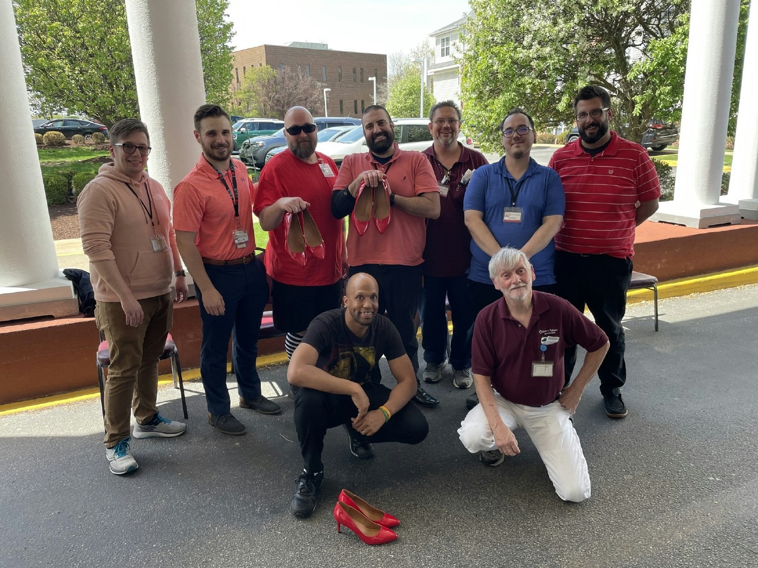 Employees volunteer to walk in red heels for the Walk a Mile event to raise proceeds for the Blackburn Center