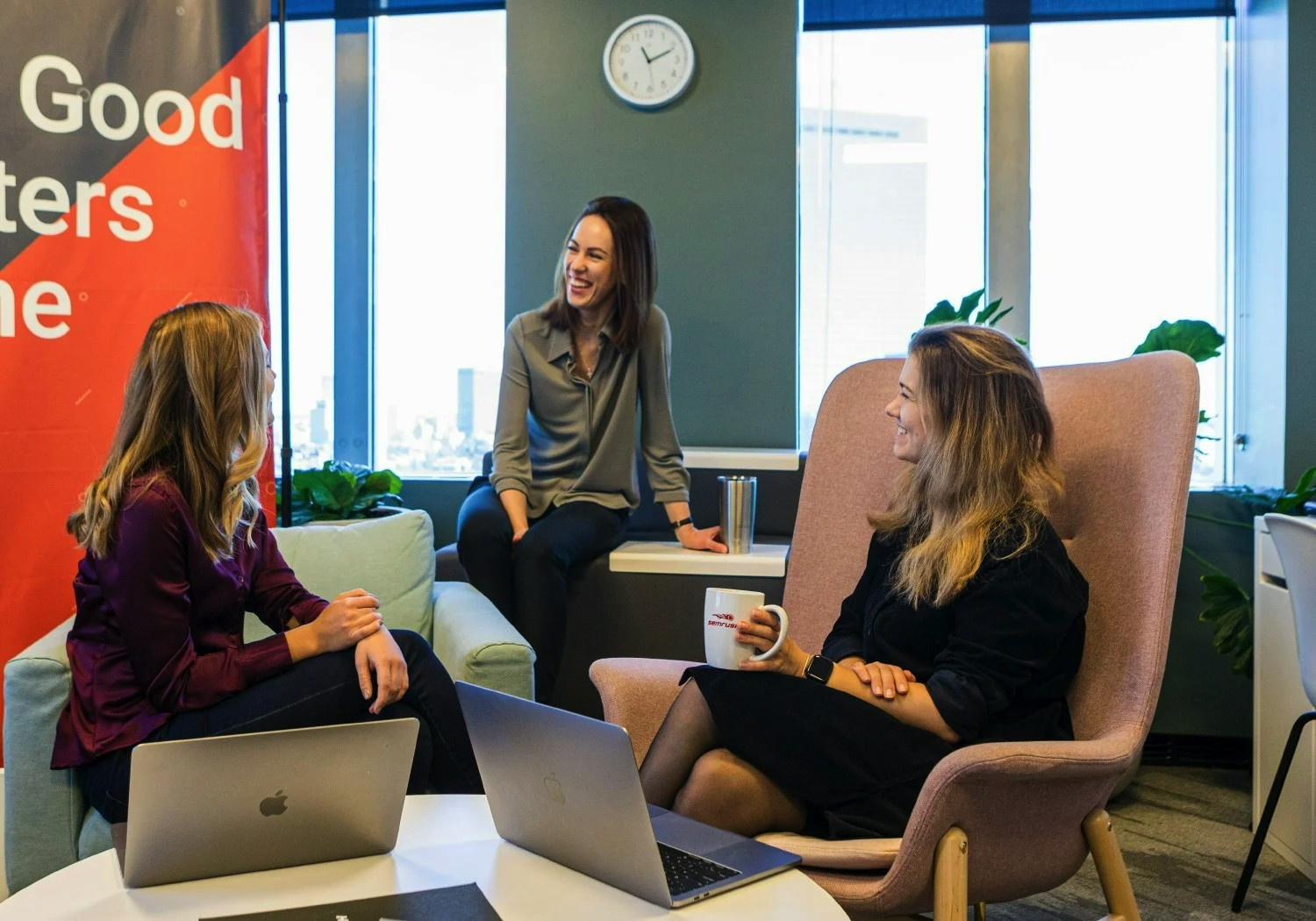 Two employees chat in a communal working space at the Trevose, PA office