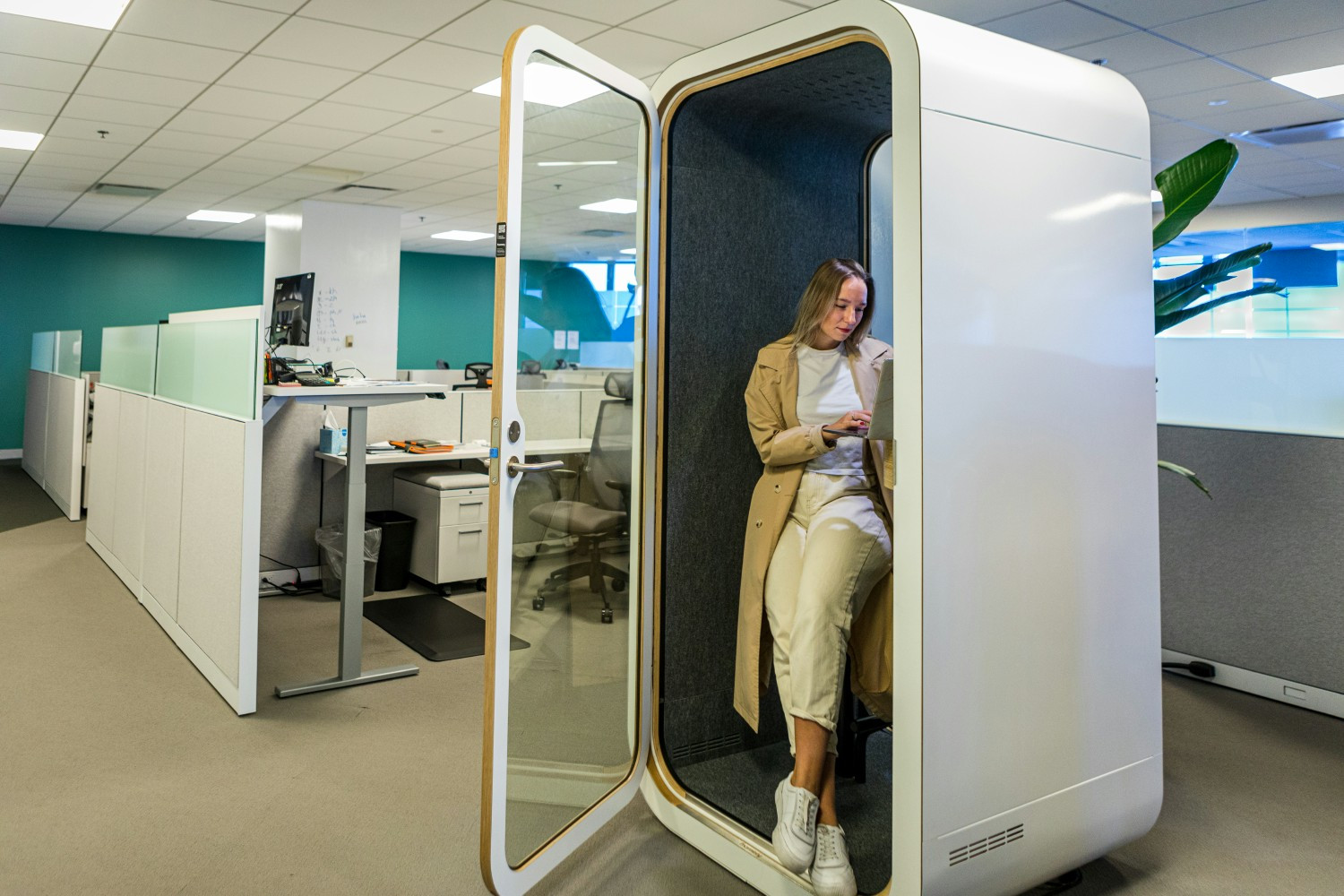 An employee uses one of the Boston office's private quiet rooms for an online meeting with a colleague abroad.
