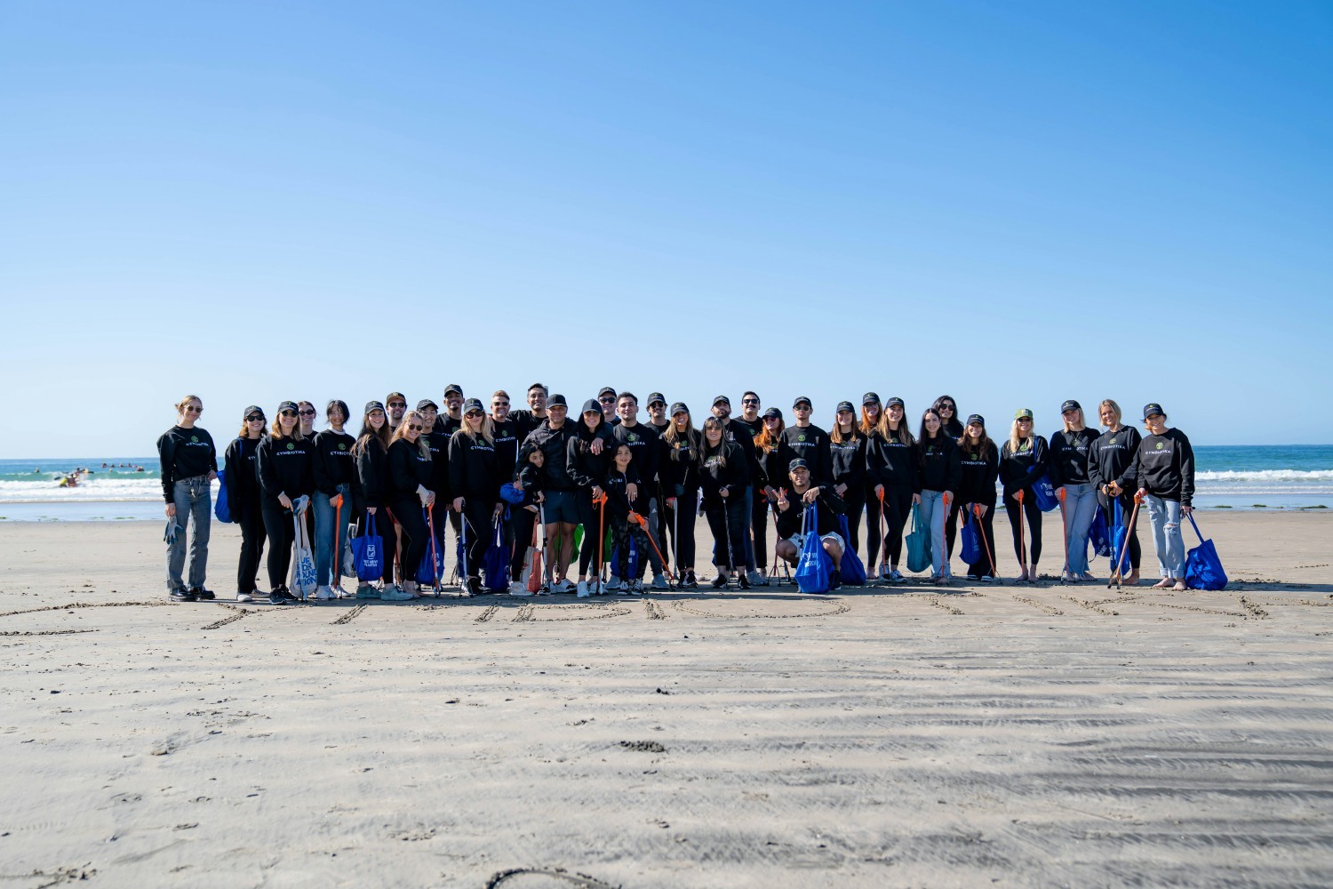 Cymbiotika team members in La Jolla doing a beach clean up.