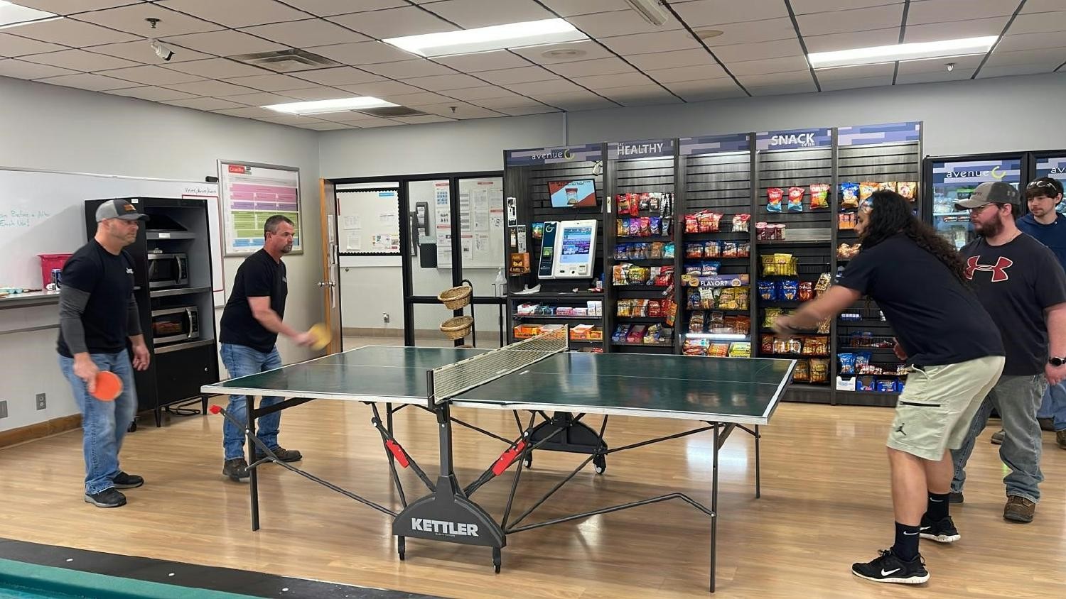 Oak Ridge, Tennessee employees participating in a ping pong tournament to raise money for Family for Families program.