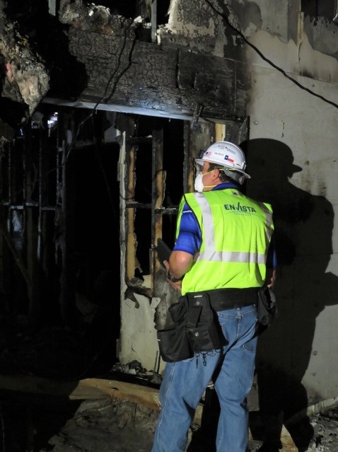 Envista Team Member surveying the remains after a fire blazed through the structure