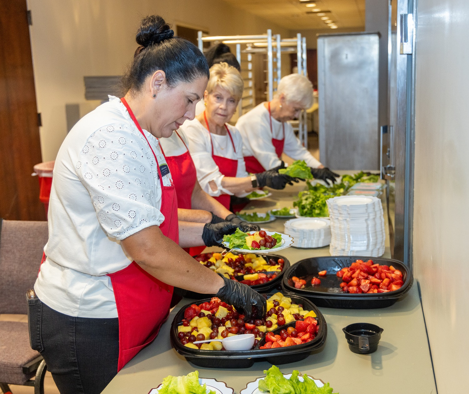 Walton Communities team members serving at the annual Legacy Luncheon with non-profit partner, Mission 1:27.