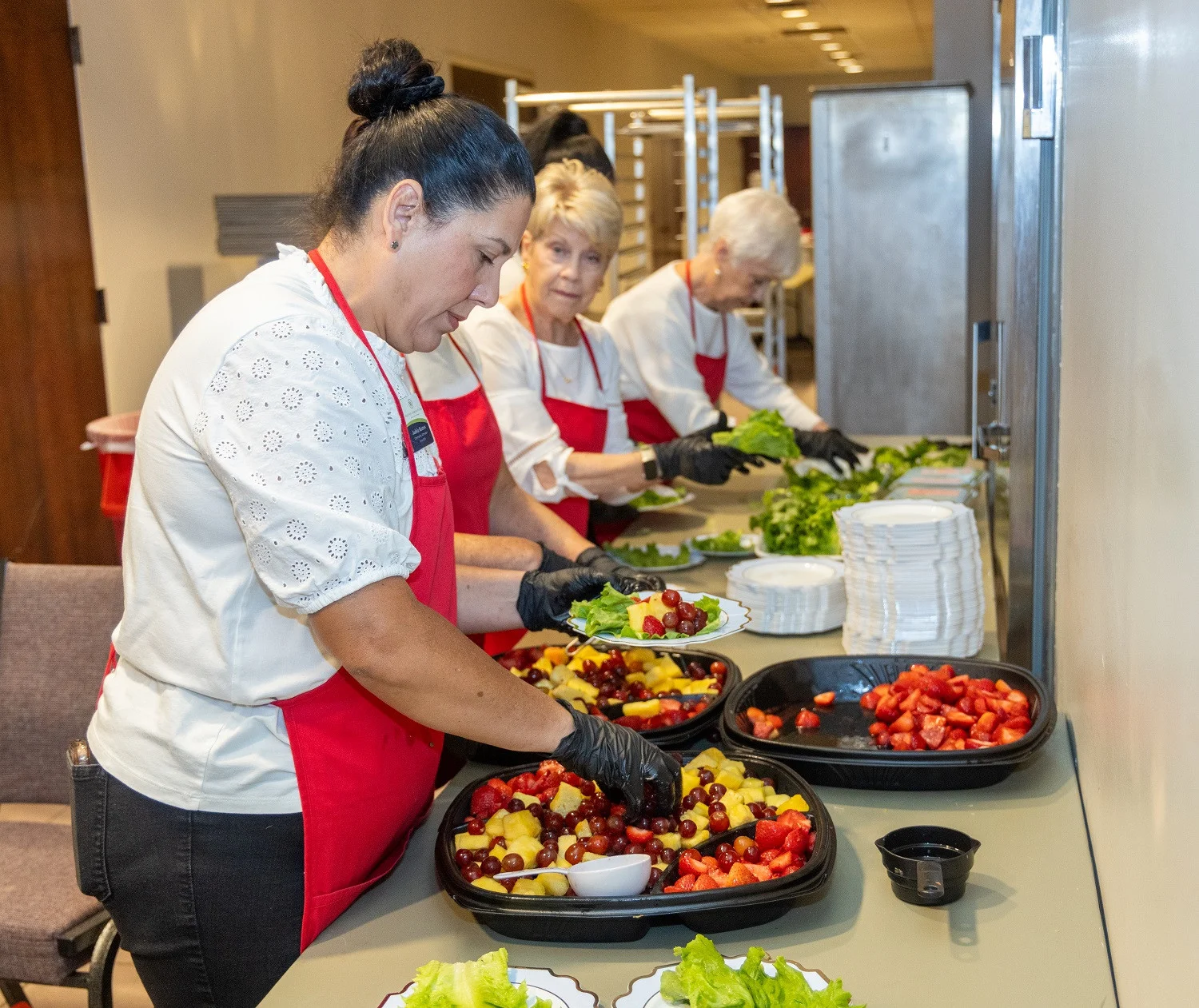 Walton Communities team members serving at the annual Legacy Luncheon with non-profit partner, Mission 1:27.