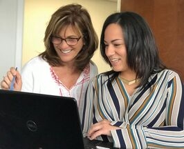 Two of our team members, Jeanette and Brenda working together on a project.