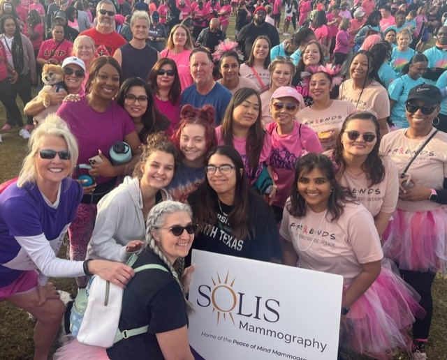 Team members participate in the Susan Komen Walk in Dallas.
