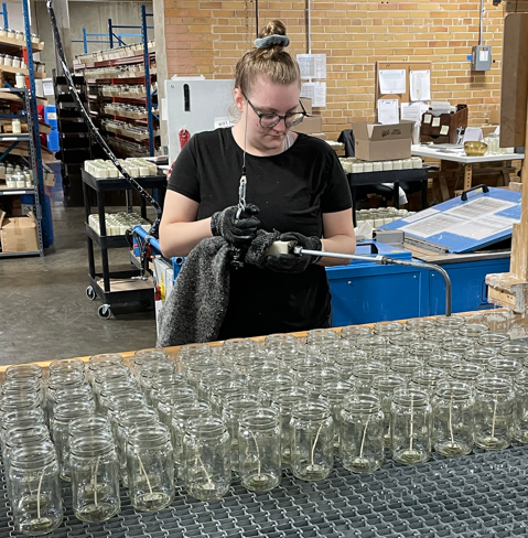 Kelley pouring our flagship mason jar candles