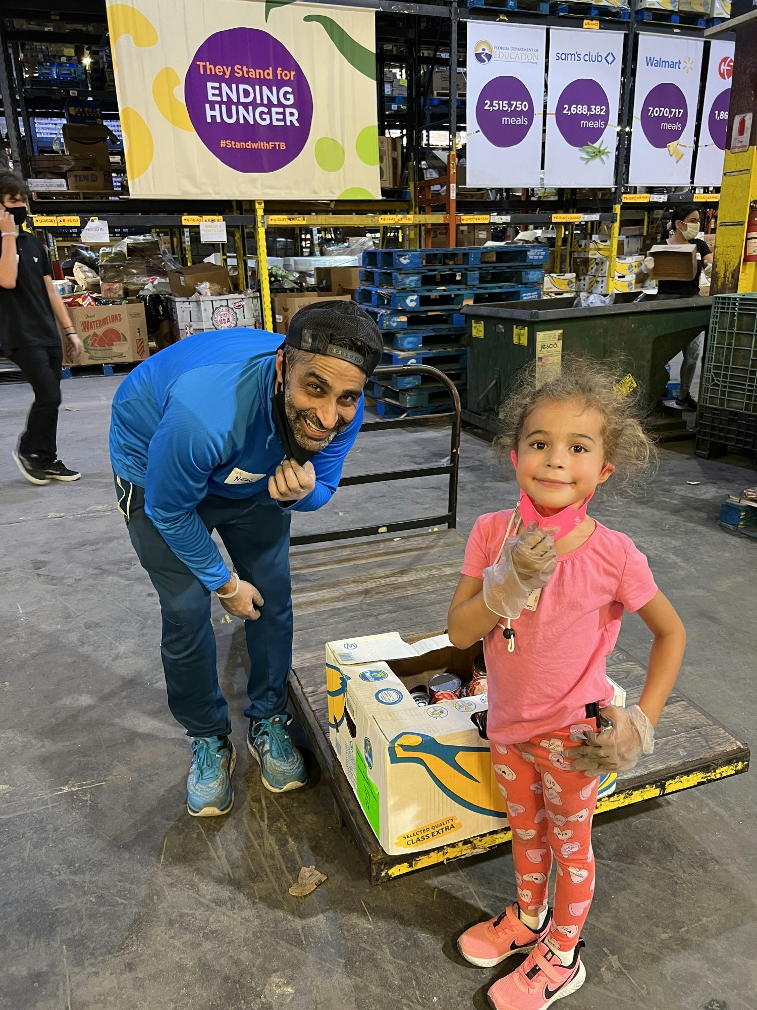 Our CEO, Neil Vaswani, and his daughter volunteering at a local non-profit. 