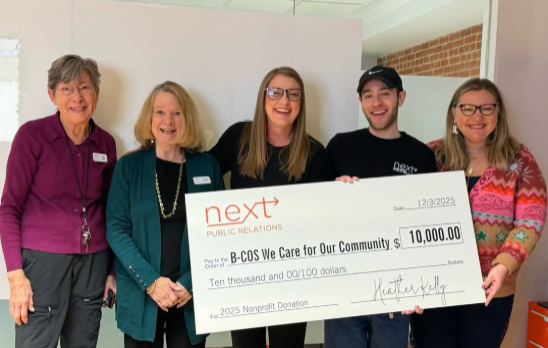 Next PR gifting 2025 Conscious Capitalism Partner, B-COS We Care, a $10,000 check as thanks for their community impact a