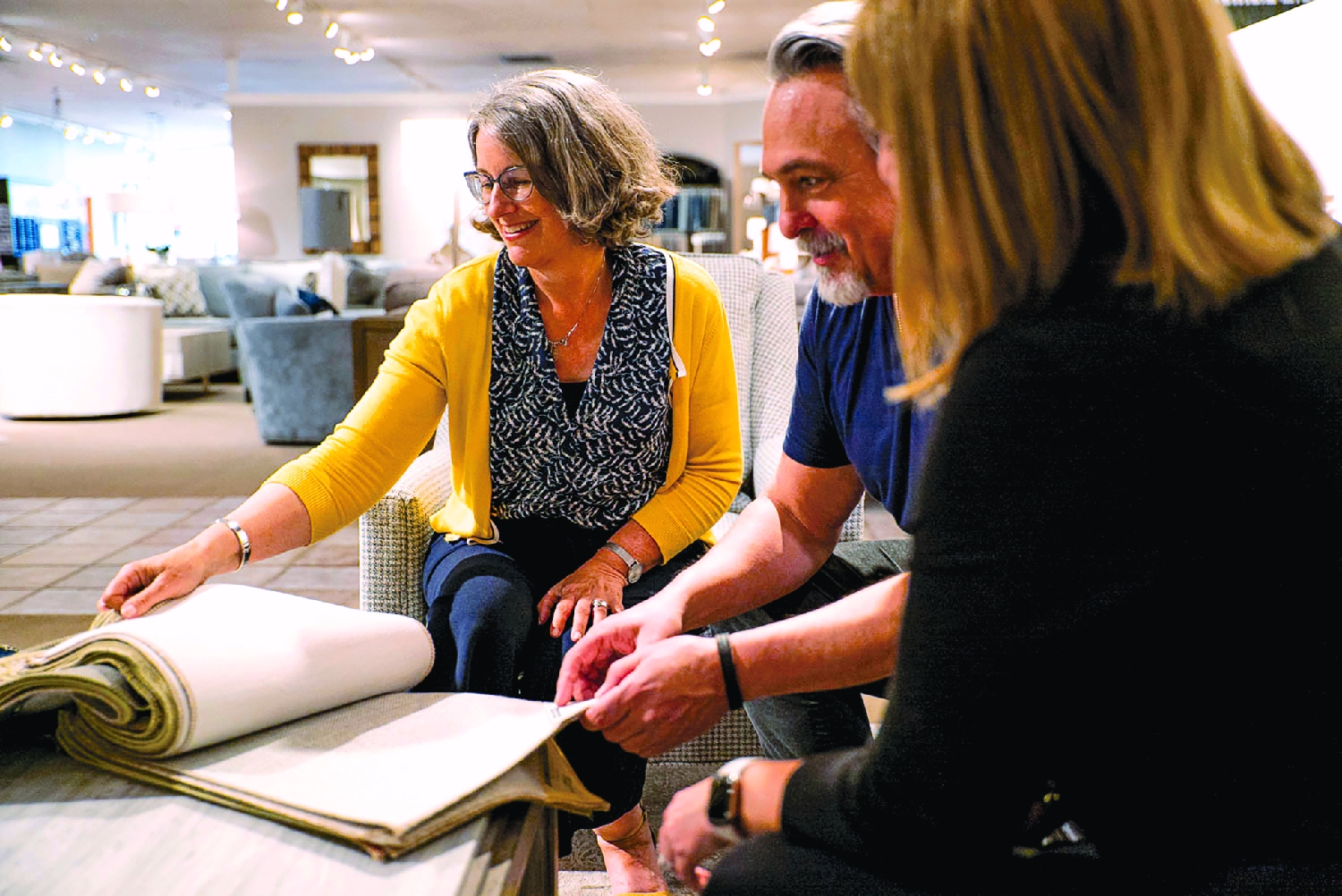 Anne working with fabrics in showroom.