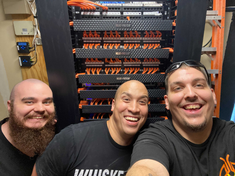 Firefly teammates work together to update a clients' network closet. 