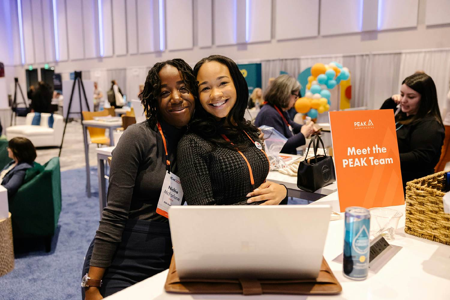 Staff members Nichia Courville and Rahmirah Gardner at the PEAK2024 lounge, a popular connection point for members.