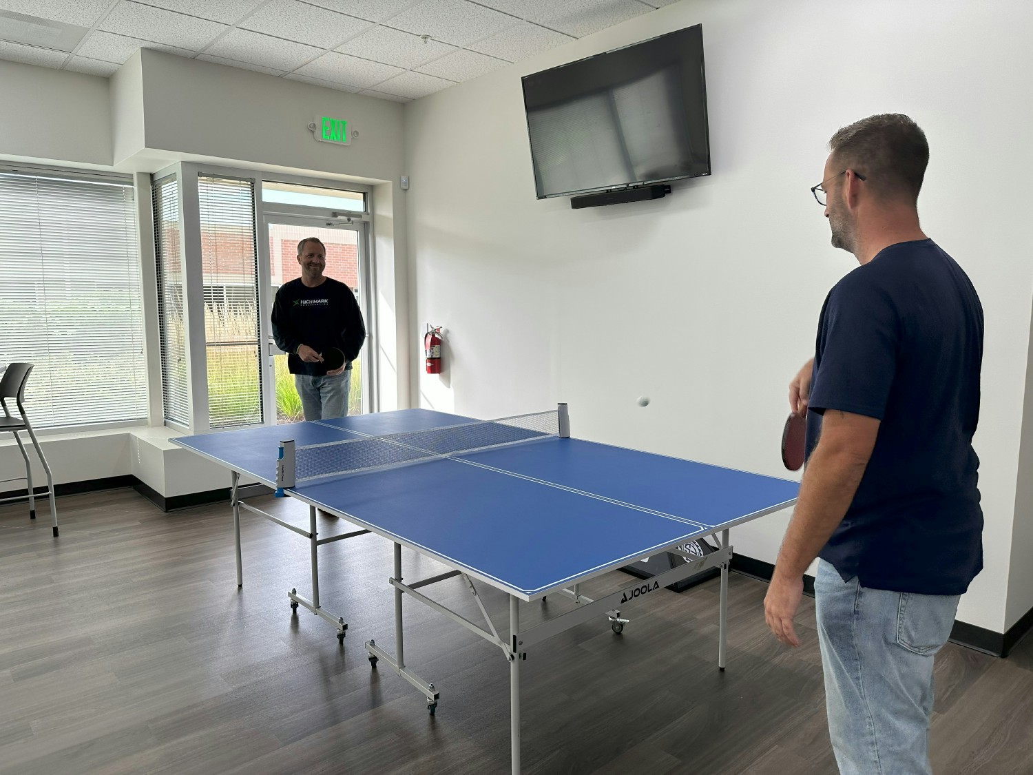One of the bosses, Mike Kimball and employee Ed, playing a friendly game of ping pong. 