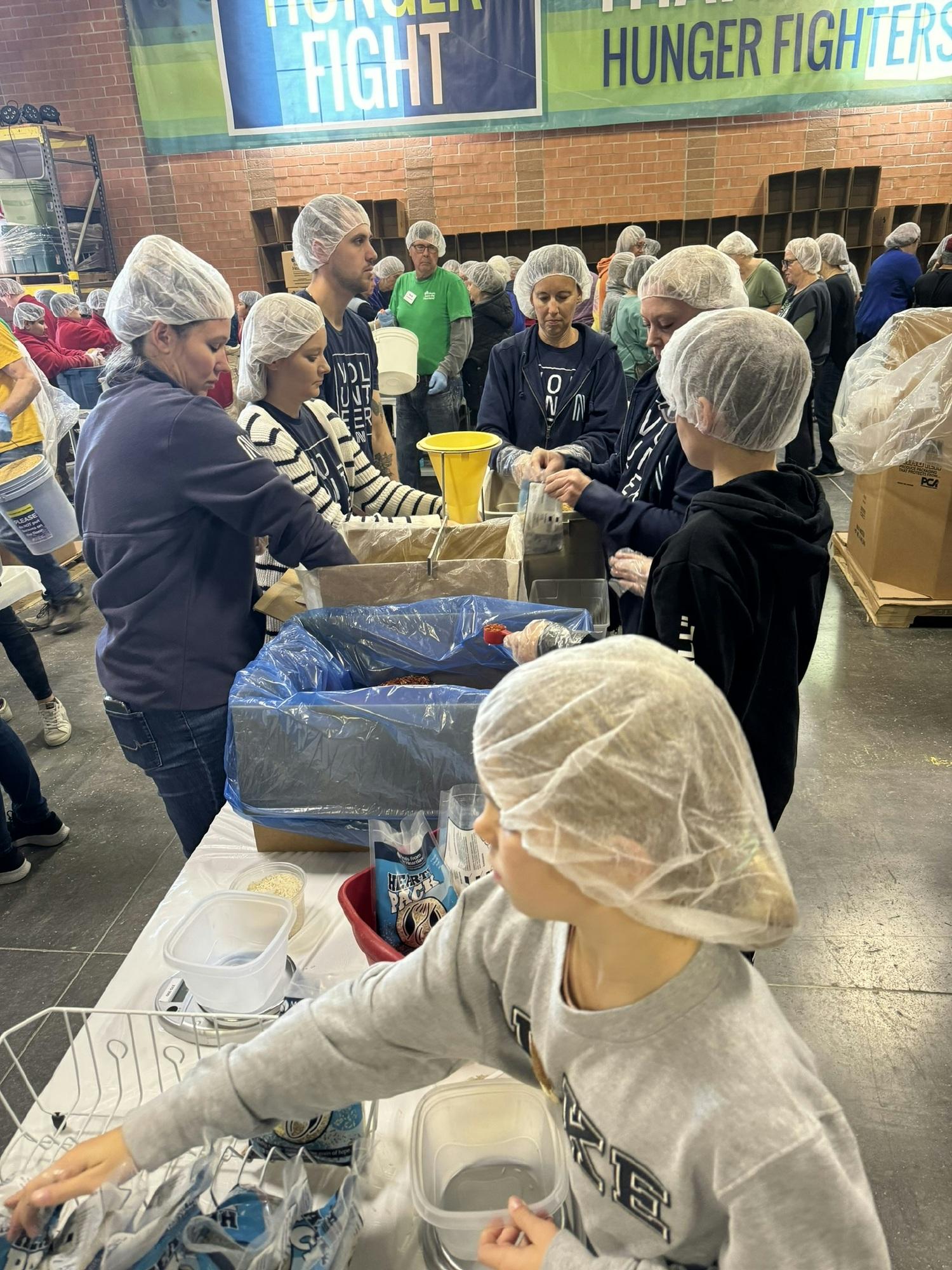 Navigate Team members help feed others! Meals from the Heartland!