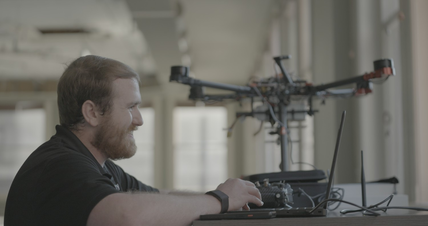 Heath calibrating a drone purchased using Infinity's employee tech stipend. He's stoked because the stipend is awesome. 