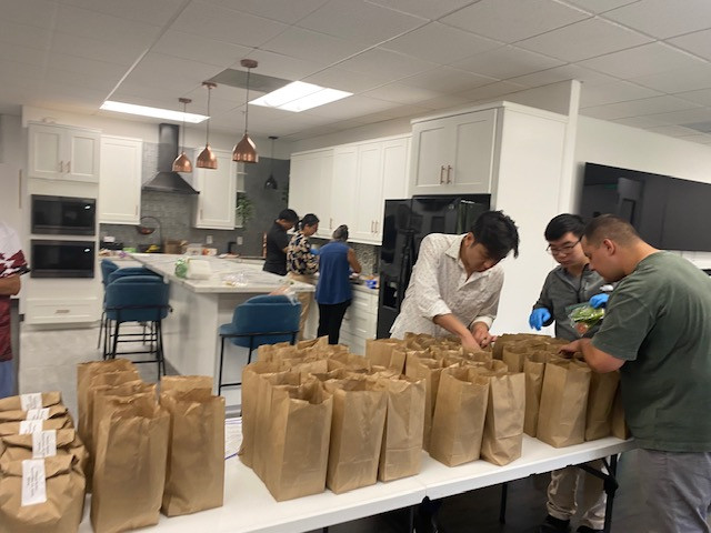 Civiltec employees preparing sack lunches to support those in need.