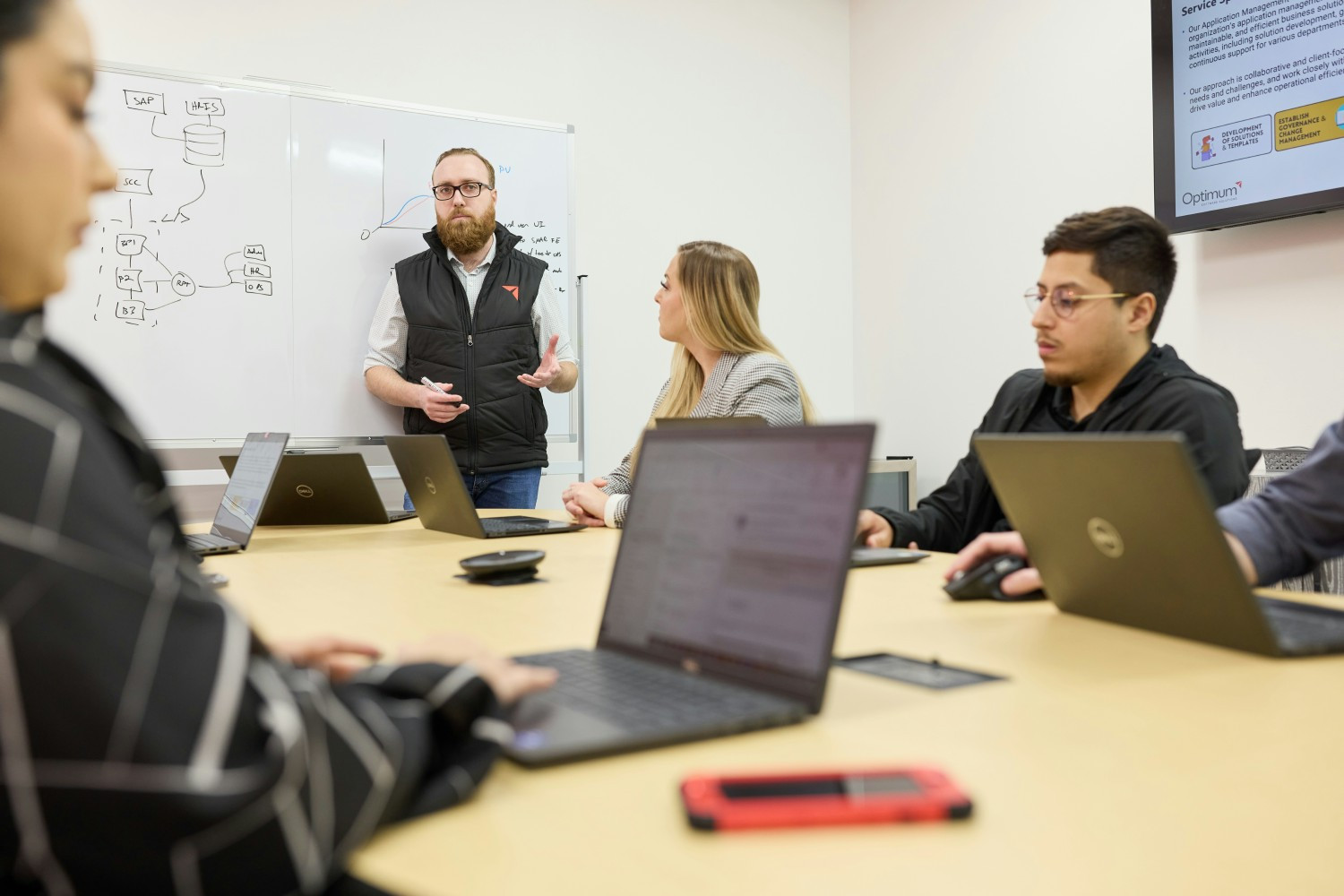 Team members collaborating at Optimum's HQ office.