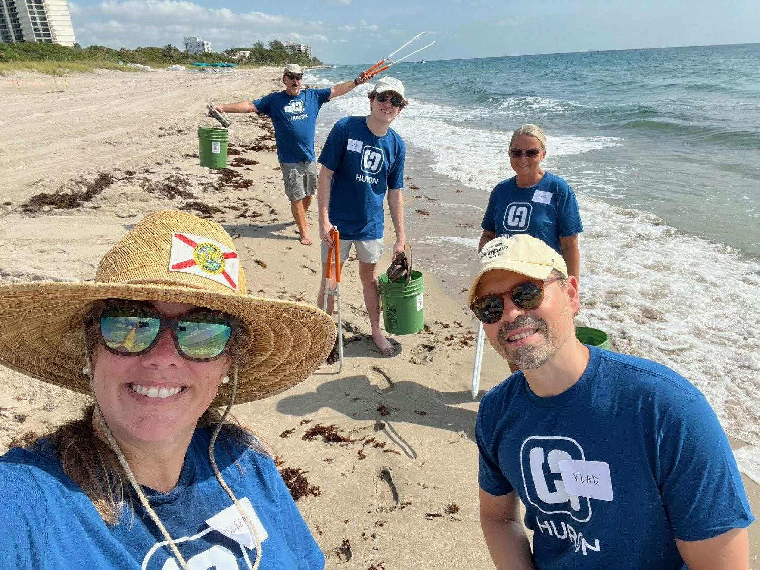 Volunteers gather on the shores of Boca Raton, Florida, for a beach cleanup, collecting litter and removing debris