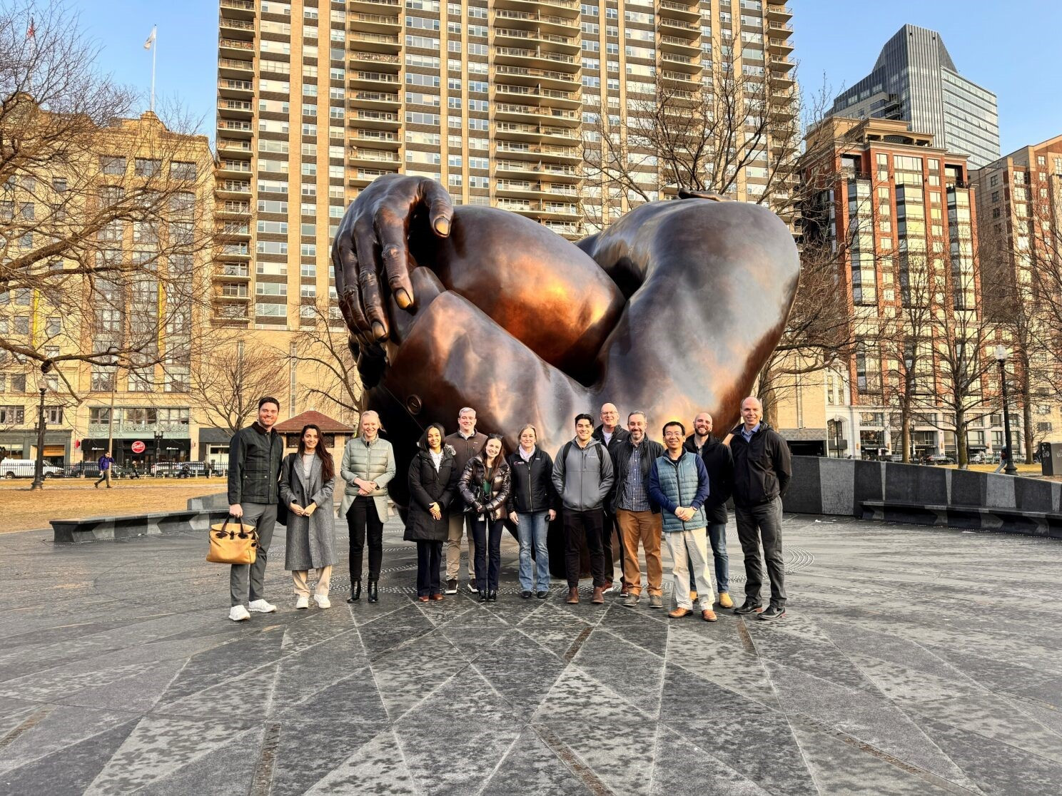 Employees visiting the Embrace Monument
