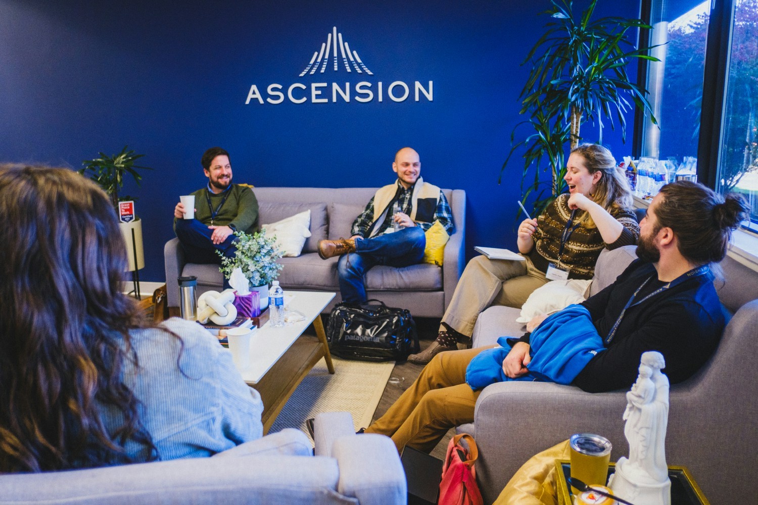 Ascension's Corporate Marketing team engaged in discussion during a team meeting.