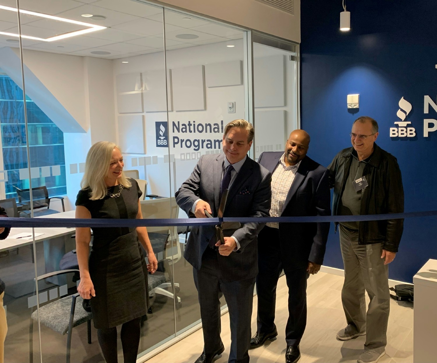 Members of the leadership team and Board of Directors gathered together for a ribbon-cutting of our new New York office.