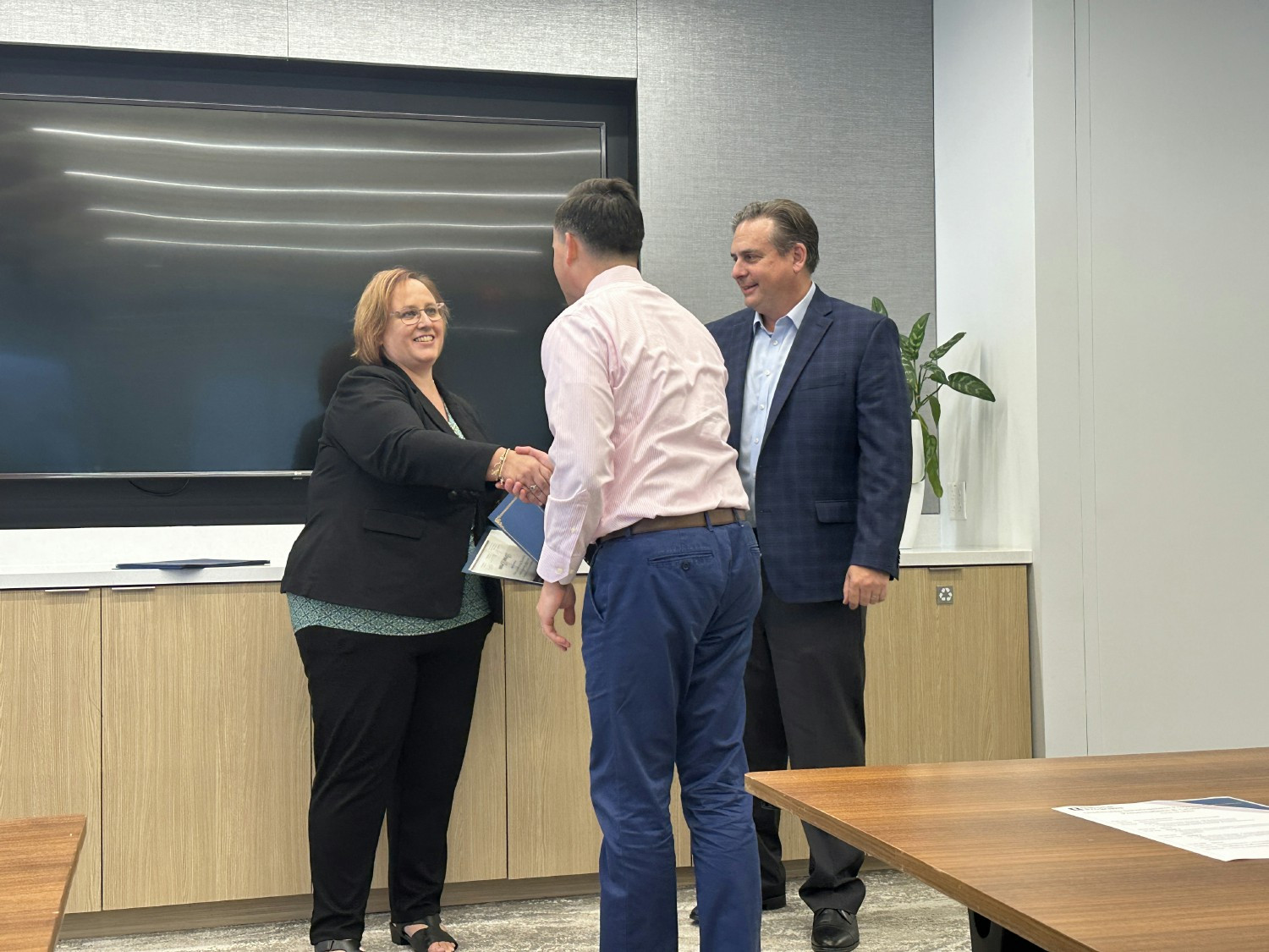 BBB National Programs’ Amy Clark and Eric Reicin present a certificate at an internal professional development program