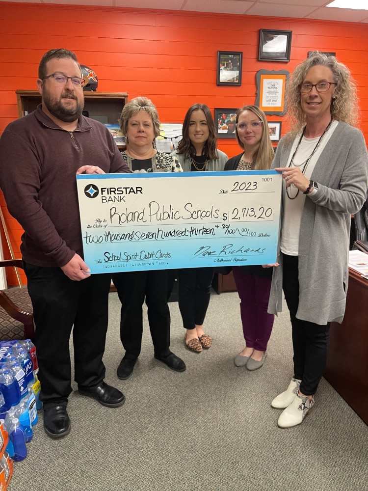 Roland employees give Roland Public Schools money accrued through our School Debit Card Program. 