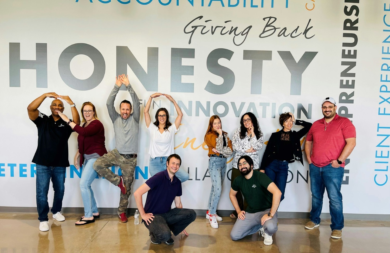 Marketing Team in front of the Values Wall in Corporate Headquarters