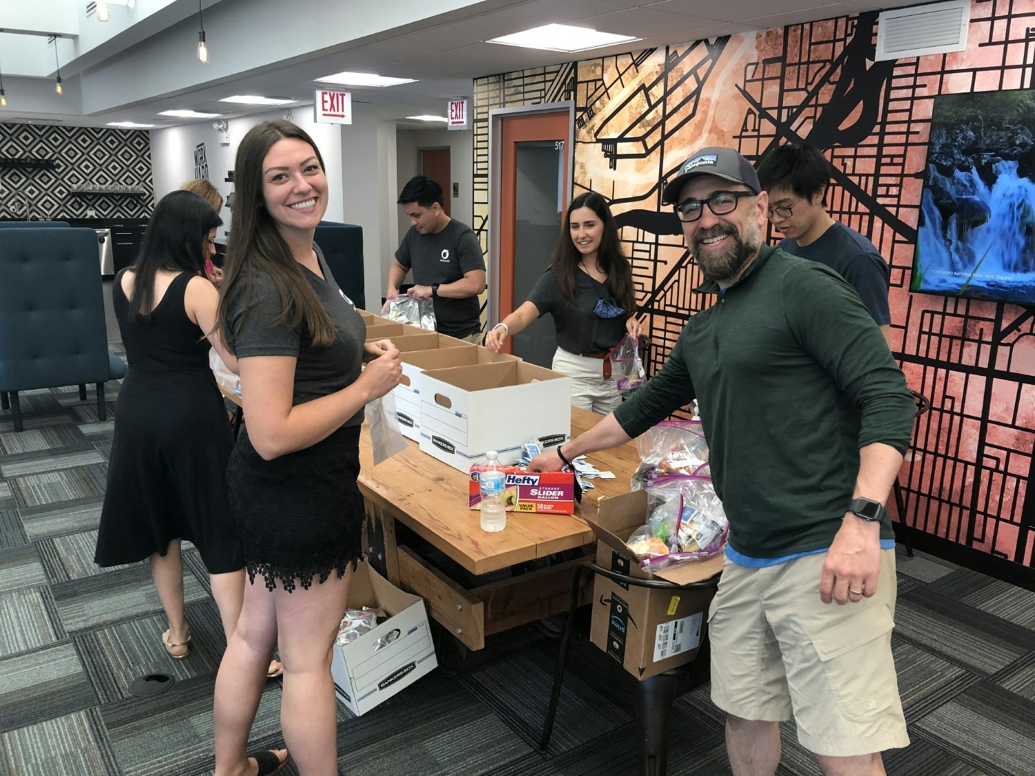 Arcalea team members came together during Arcalea Gives Back Day to create snack packs for local individuals.