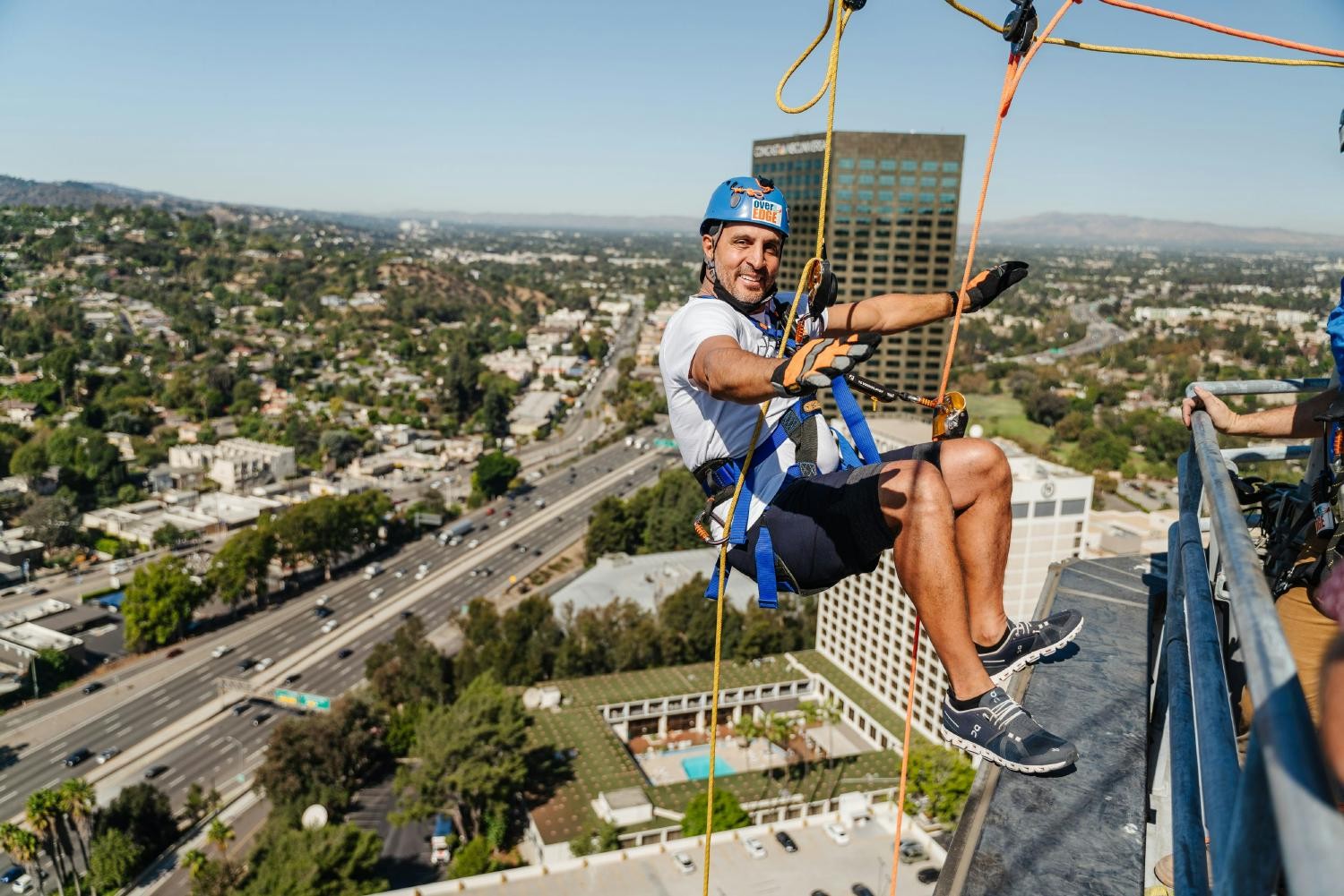 CEO Mauricio Umansky repelling off a building for charity event