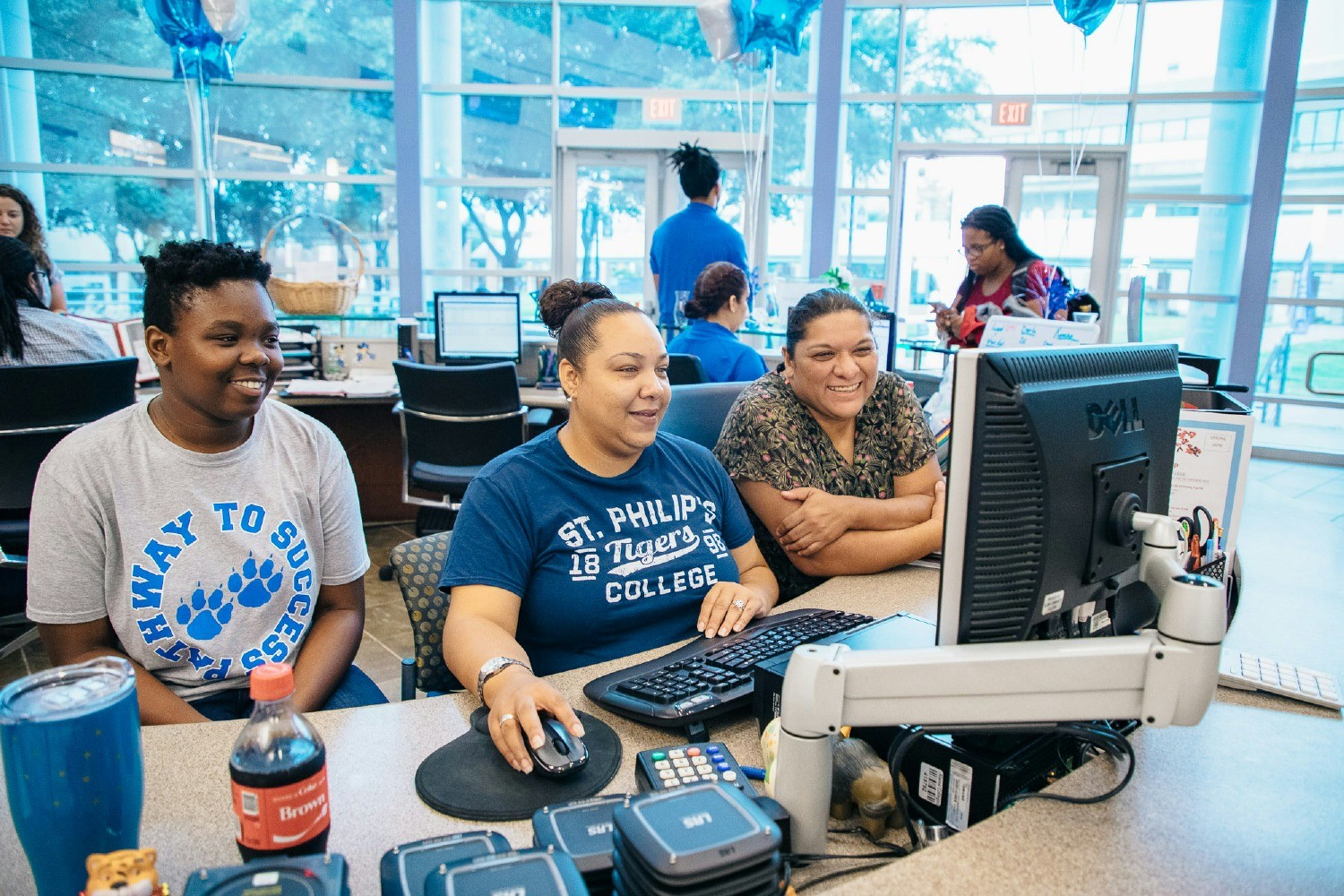 A St. Philip’s College employee helps team members navigate new technology