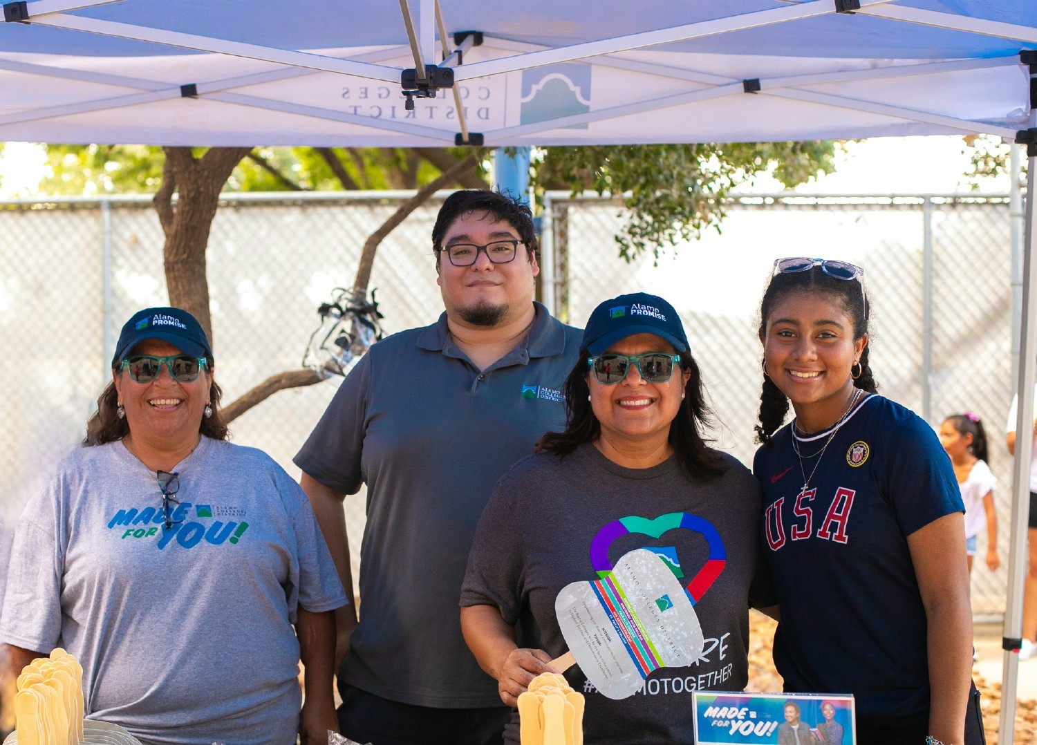 Alamo Colleges District employees participate in a community event to promote free tuition as part of the AlamoPROMISE