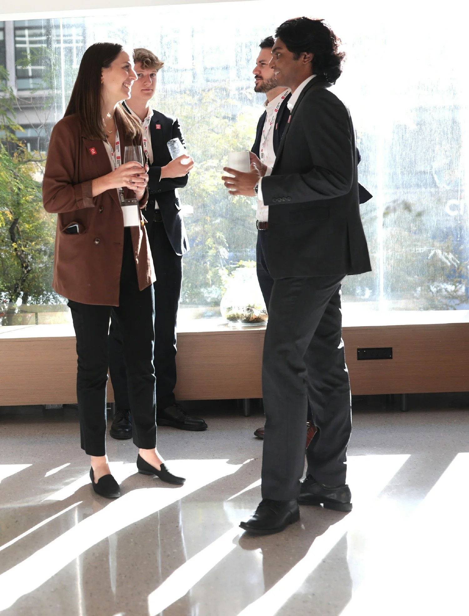 O.W. employees engaged in discussion at an event bringing industry leaders together to discuss shared ownership.