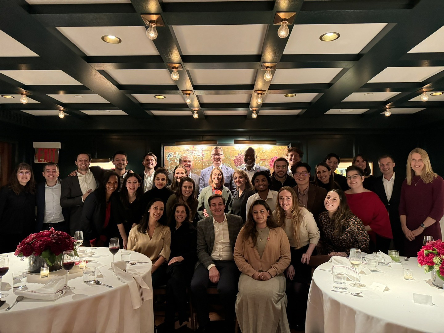 The entire O.W. team at its annual holiday dinner, hosted by O.W. founder Pete Stavros and his wife Lindsay Stavros.