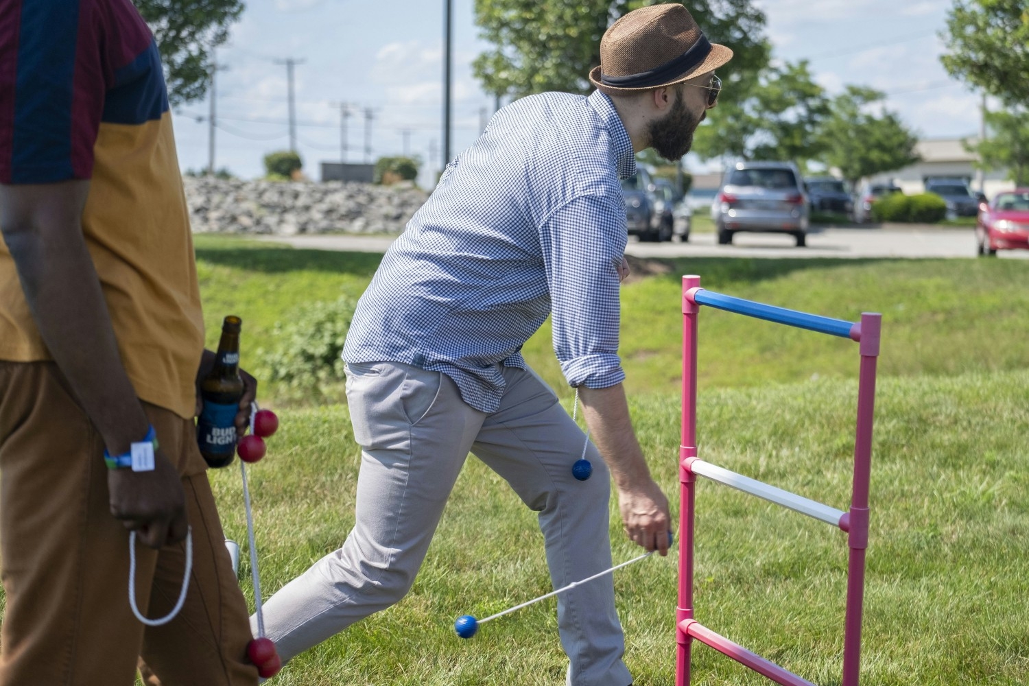 Ian Otenti playing a lawn game during a company grill day, which are hosted every week throughout spring and summer.