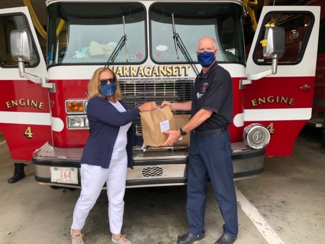 Falvey employee, Karen Tucker, delivering meals to the Narragansett fire station while volunteering with Frontline Foods
