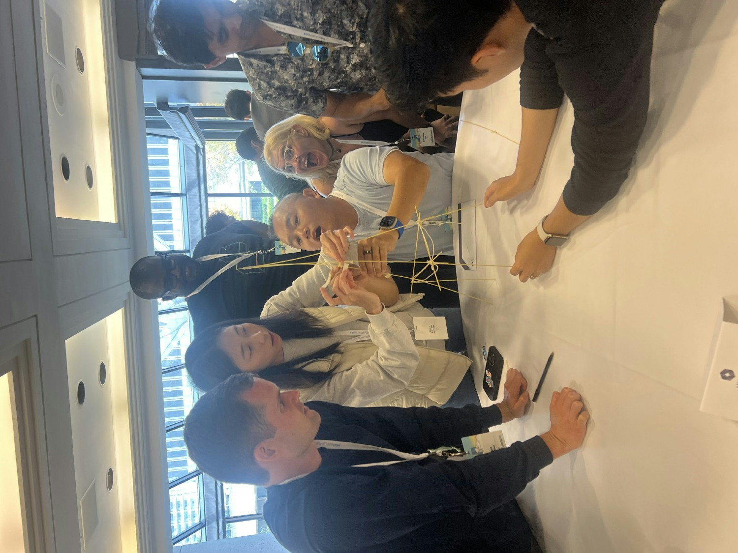Employees compete to build the tallest standing structure in the Marshmallow Challenge at our annual company offsite