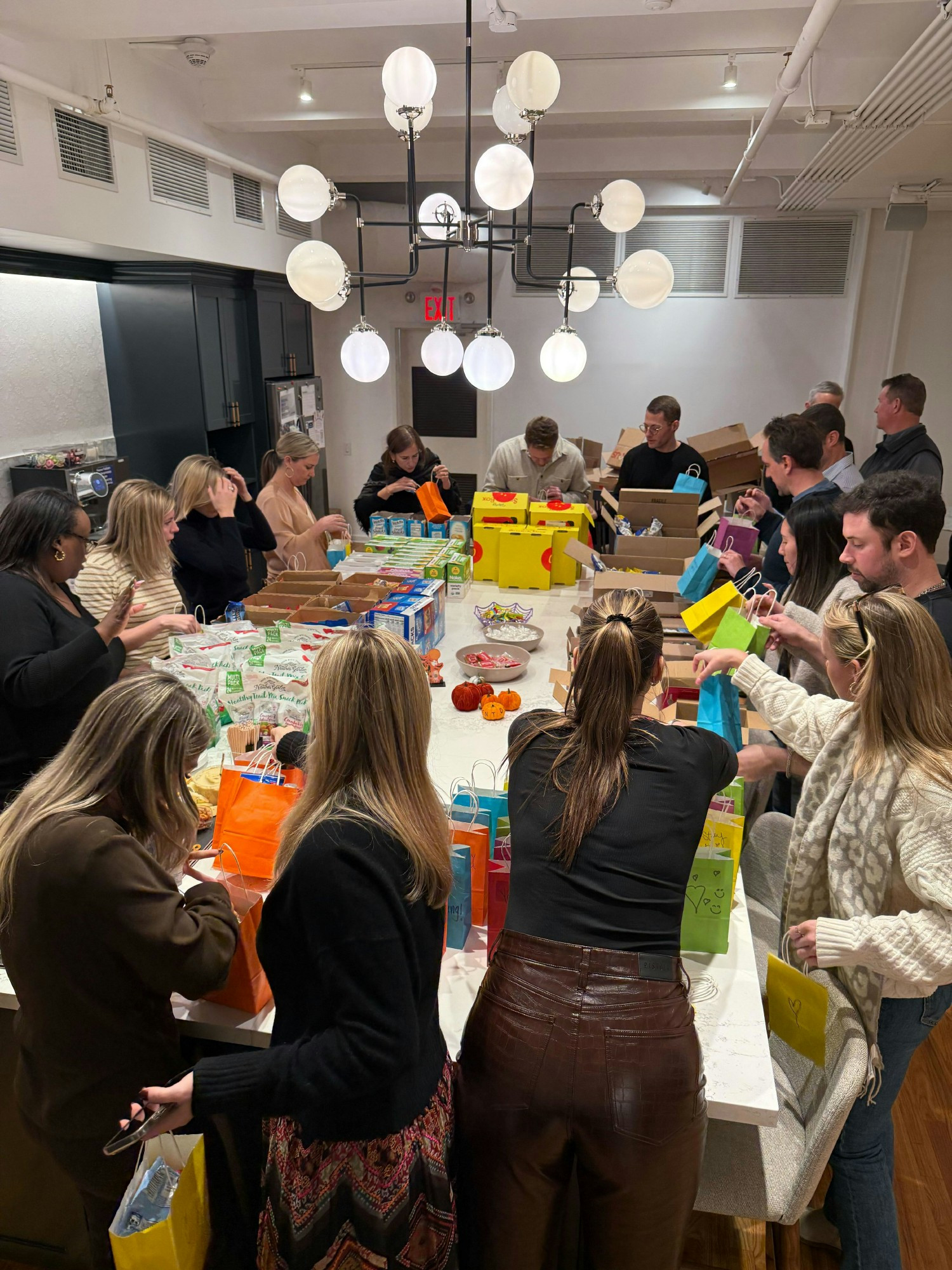 Group volunteering project in the office, putting together care packages for the Ali Forney Center.