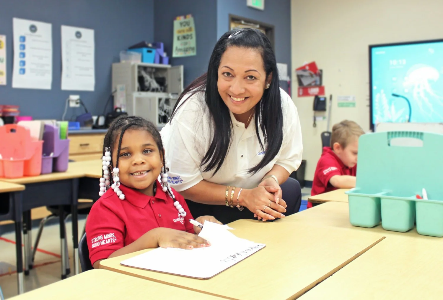 A teacher works 1-1 with students helping meet students where they are and develop their passion for learning.  