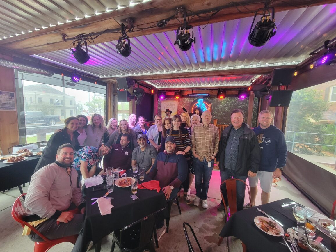 The Woodstock office getting together for a happy hour with live music.