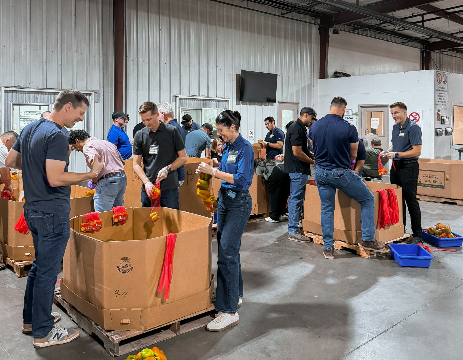 Volunteer Event - Quiring team members spend their morning sorting and packing fresh produce during a volunteer event