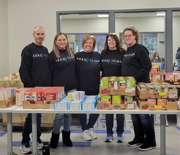 More of the team helping pass out Thanskgiving turkeys and sides at the local Rescue Mission.