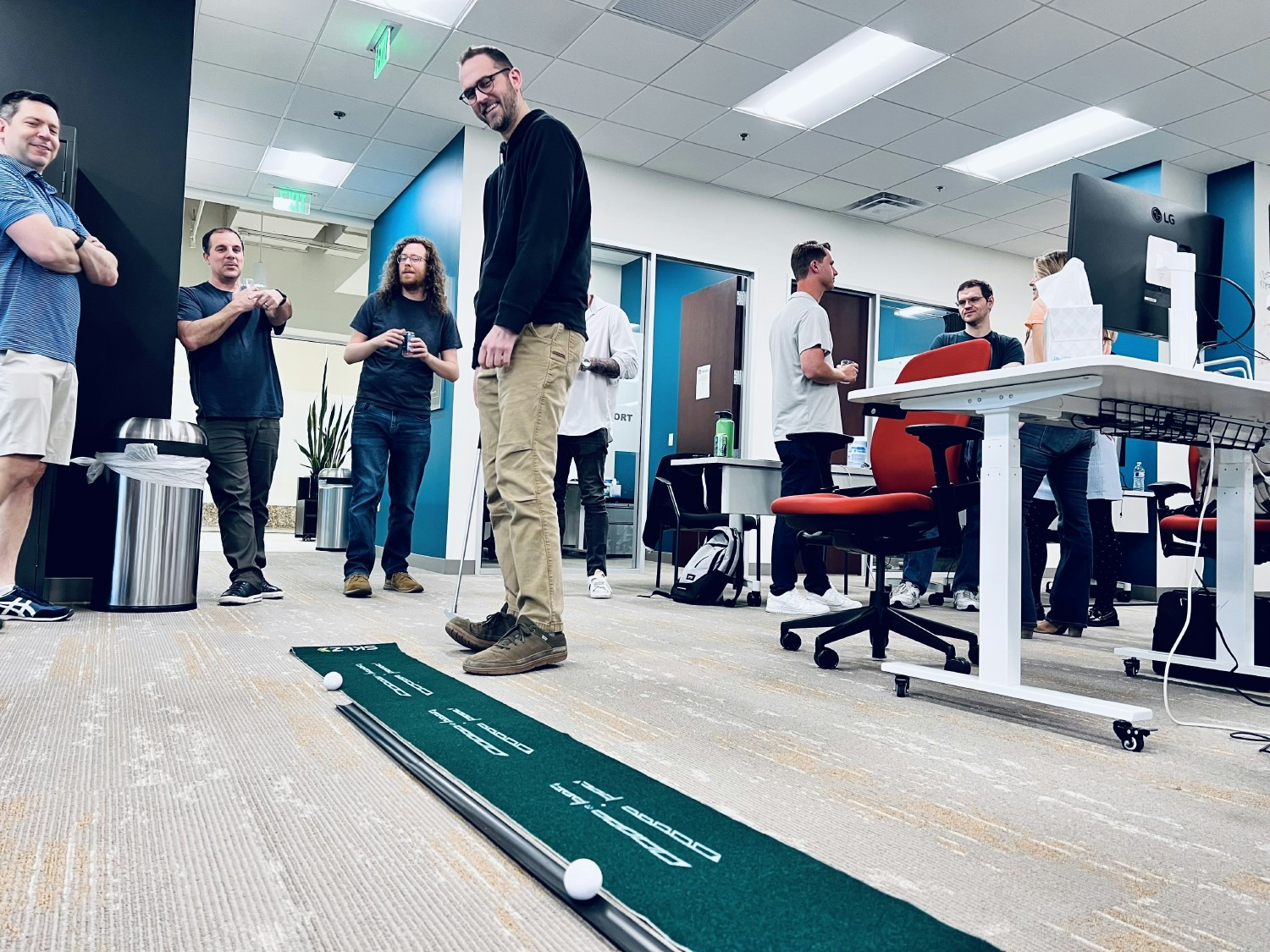 Enjoying a round of putt-putt during our office happy hour