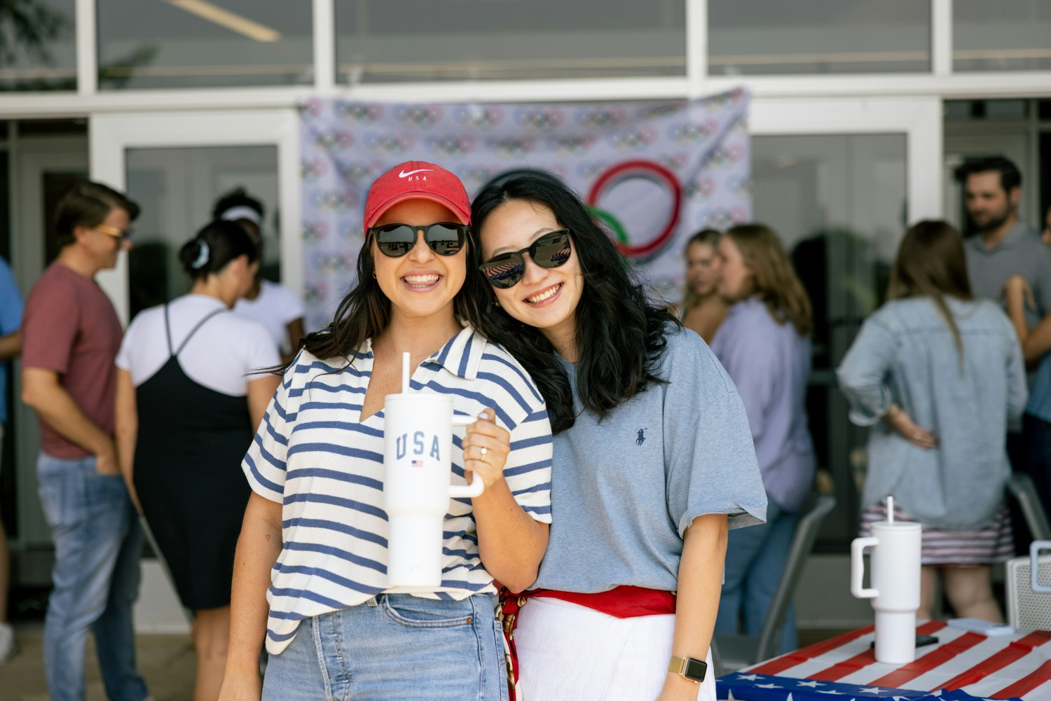 Two Simple Modern employees celebrate the 2024 Olympics at the company's Olympic-themed lunch celebration. 
