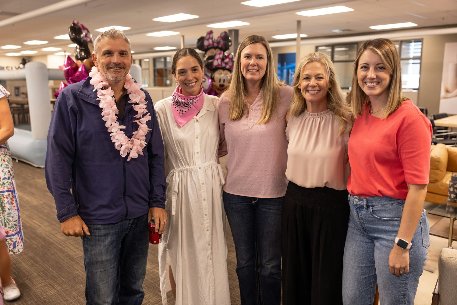 Several Simple Modern employees gather during a Make-A-Wish lunch for a child and their family bound for Disney World. 