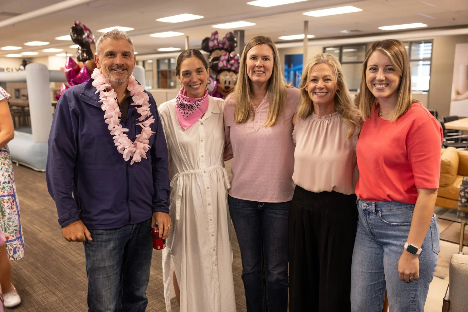 Several Simple Modern employees gather during a Make-A-Wish lunch for a child and their family bound for Disney World. 