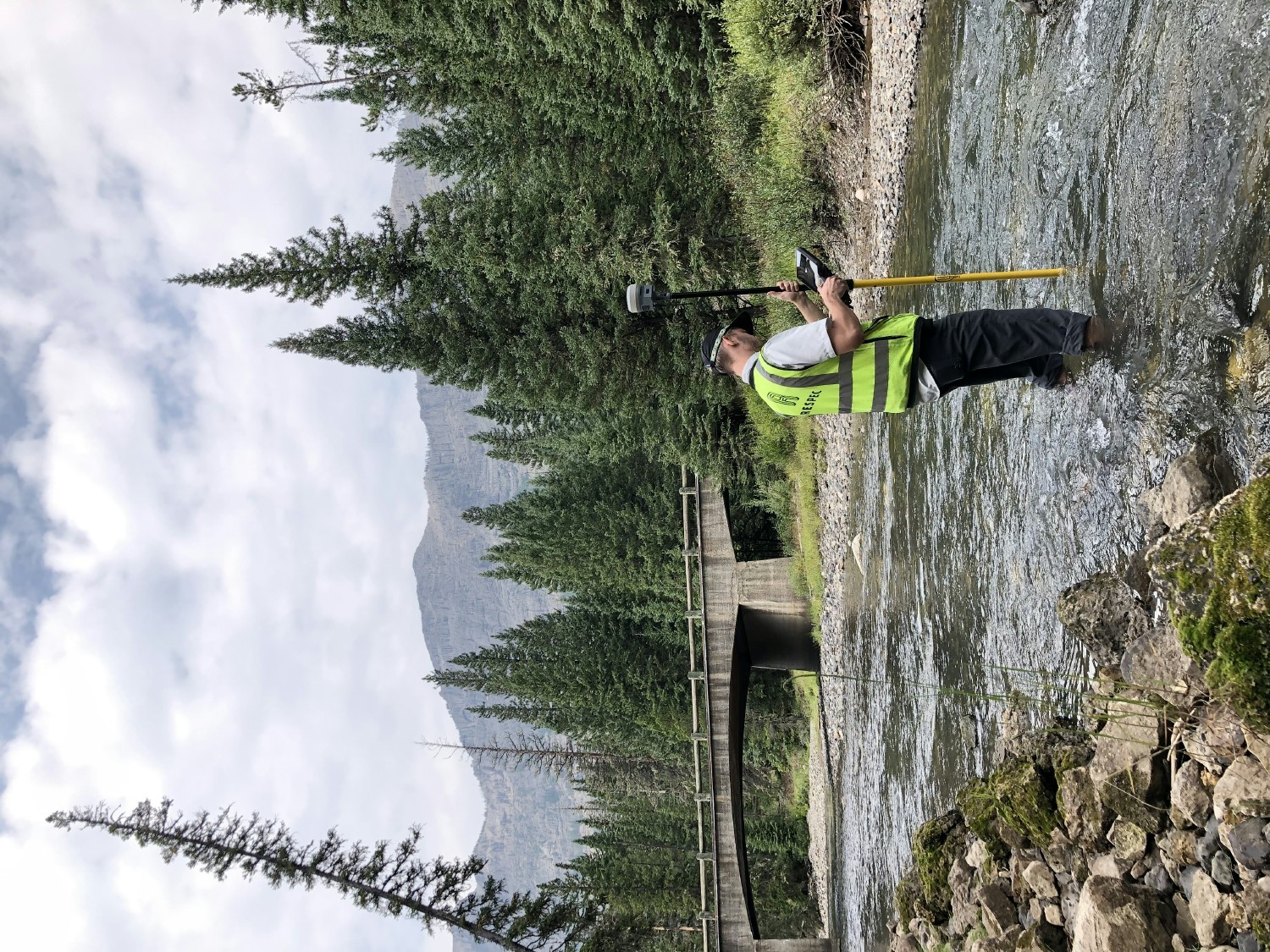Bozeman office employee working on survey in Soda Butte Creek in Yellowstone National Park.
